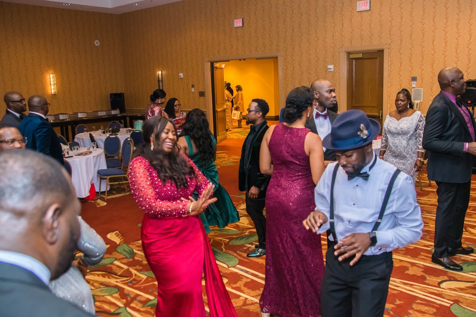 Wedding MC on stage with elegant reception decor in Atlanta